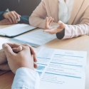 Hands of three people in a job interview