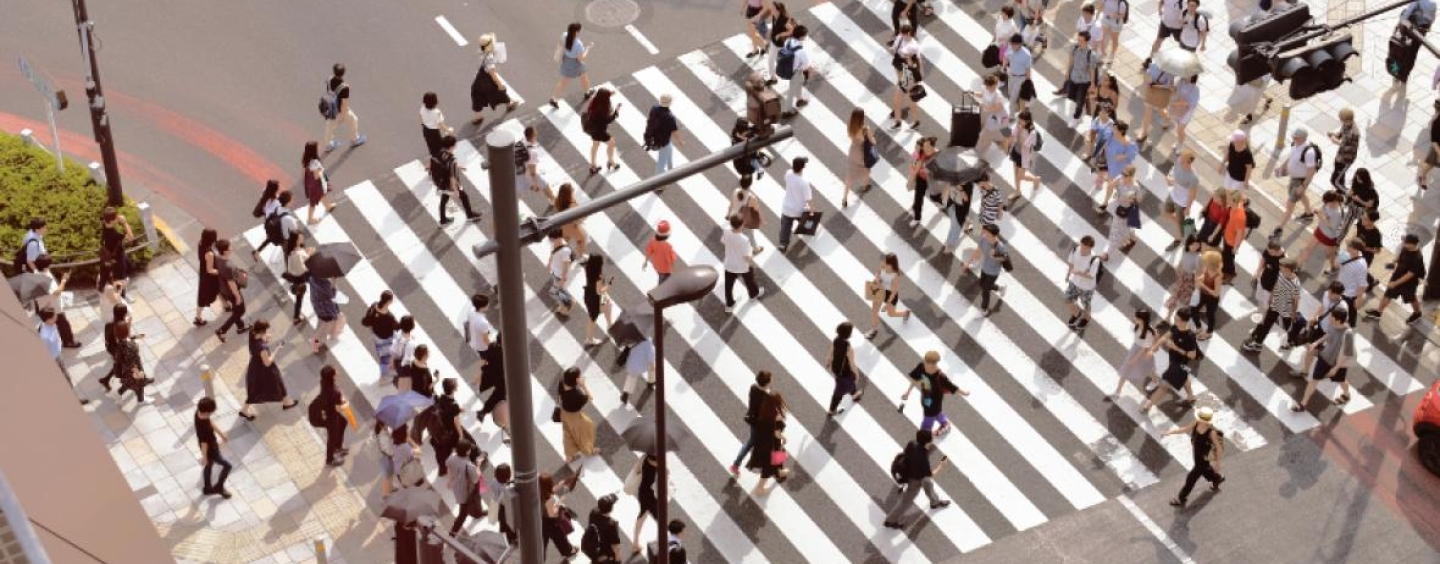 Group of pedestrians crossing a large crosswalk